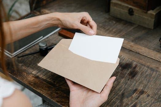 Business letter being pulled from an envelope